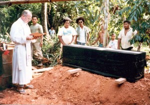 Father Horgan saying prayers at a Yapese funeral.